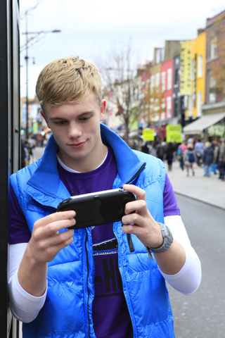 Illustration for article titled Attractive Young Men Smiling at the PlayStation Vita